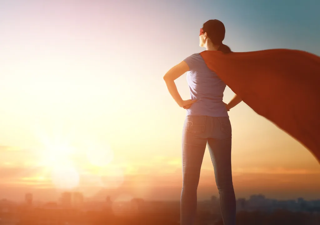 A Hollywood superhero posing in front of the sun